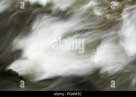 White water patterns in rapidly flowing river Stock Photo