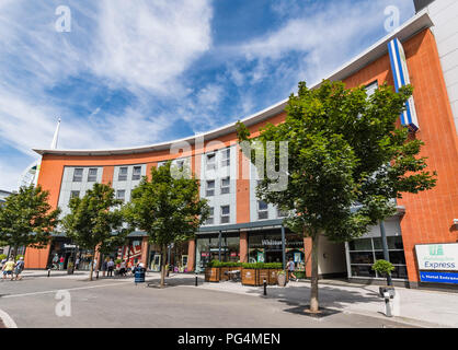 Row of shops underneath the Holiday Inn Express in Gunwharf Quays in Portsmouth, Hampshire, England, UK. Stock Photo