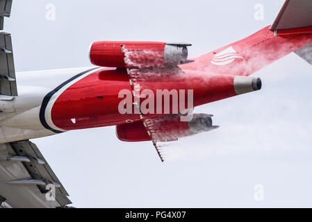 Spraying unit boom arm of Oil Spill Response Boeing 727 plane at the Farnborough International Airshow, using water instead of dispersant chemicals Stock Photo