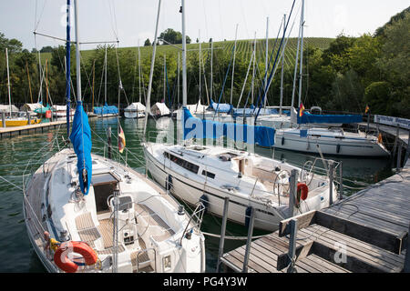 Yachts moored at a small marina with a backdrop of vineyards, near Meersburg, Lake Constance (Bodensee), Germany. Stock Photo