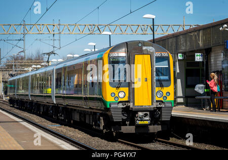 London Midland trains passenger train class 350 travelling at a station on the Abbey Line, Hertfordshire, UK. Stock Photo