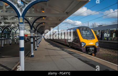 Class 220 Voyager passenger train in CrossCountry livery at a platform at a railway station on the east coast main line, England. Stock Photo