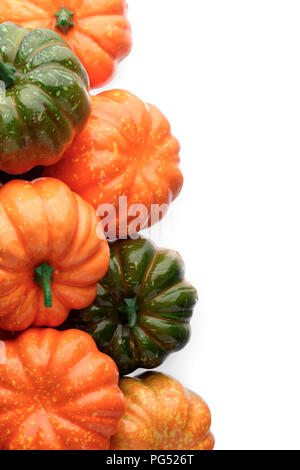 Group of orange and green pumpkins, closeup shot, white background, seasonal design element Stock Photo