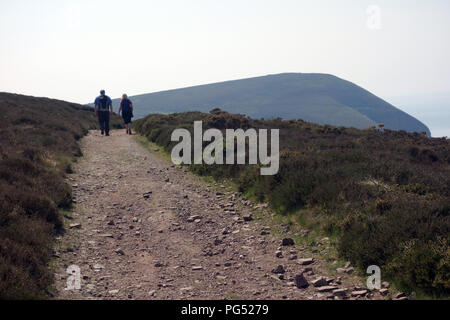 A Couple Walking on Holdstone Down Towards Great Hangman Hill on the South West Coastal Path, Devon, England, UK. Stock Photo