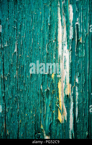 Detail of cracked and peeling green paint on an old wooden fence Stock Photo