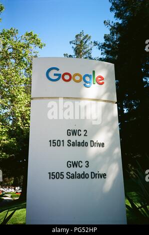 Sign for Google Inc in a wooded area at the Googleplex in Silicon Valley, Mountain View, California, April 14, 2018. () Stock Photo