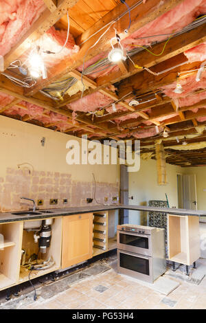 Home renovation scene with a kitchen ceiling ripout prior to a refurbishment and kitchen fitting Stock Photo