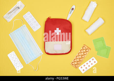 top view of first aid kit with various medicines isolated on yellow Stock Photo