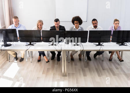 Skilled Young Business Executives Working On Computer In Office Stock Photo