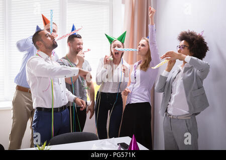 Group Of Young Businesspeople Celebrating New Year Party In Office Stock Photo