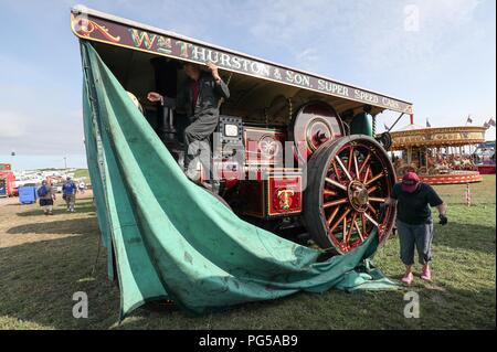Covers are removed from the Burrell Showman's Road Locomotive 'Britiannia' at the Great Dorset Steam Fair, at Tarrant Hinton, near Blandford Forum, where hundreds of steam-driven traction engines and heavy mechanical equipment from all eras, gather for the annual show which runs until Bank Holiday Monday and this year celebrates its 50th anniversary. Stock Photo