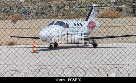 Hermoupolis Airport: August 23 . Private small plane parked in airports parking lot behind barbed wire. Hermoupolis August 23,2018, Syros, Greece. Stock Photo