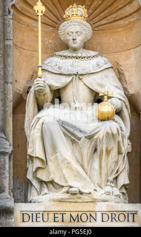Statue of Queen Elizabeth I, with orb and scepter, in a niche on the wall of Queen's Gate at Trinity college, Cambridge University, England. Stock Photo