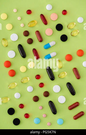 top view of arranged various pills on green background Stock Photo