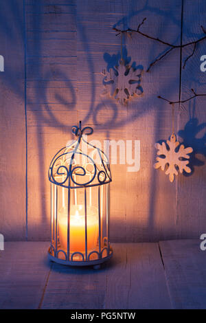 Christmas decorations and lantern at the evening . Focus on the wick candle Stock Photo