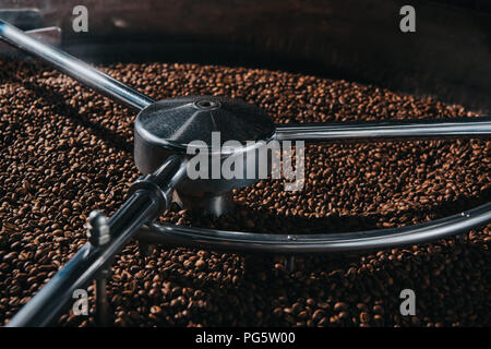 Aromatic coffee beans being roasted in professional machine Stock Photo