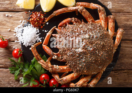 Preparation for cooking food spider crab with fresh ingredients close-up on a wooden table. horizontal top view from above Stock Photo