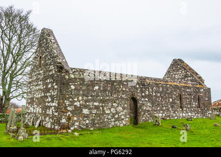 The roofless Kidalton Church, Islay, with gravestones and grass beside it Stock Photo