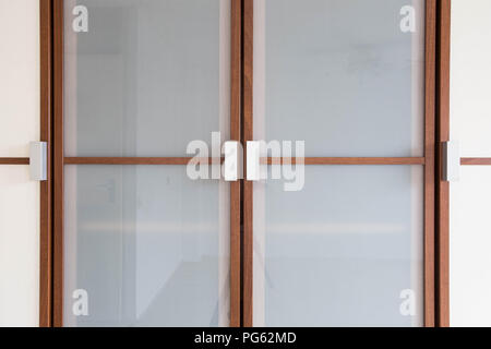 wooden white closet doors closeup for clothes modern new design Stock Photo