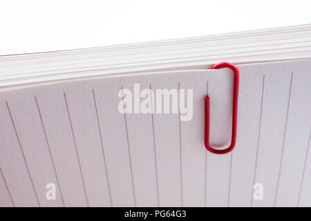 Colored paper clip on a checked notebook  page Stock Photo