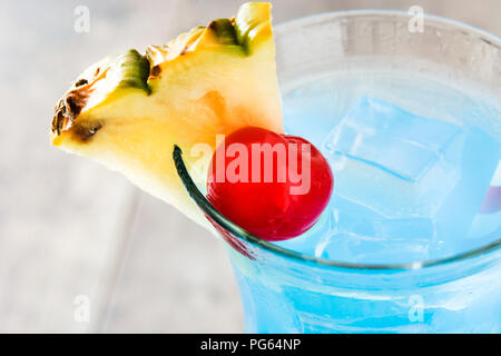Blue Hawaiian cocktail on wooden table Stock Photo