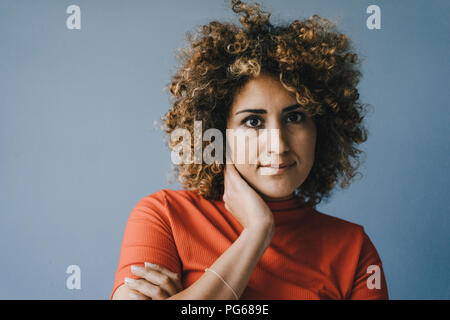 Portrait of a pensive woman with hand on chin Stock Photo