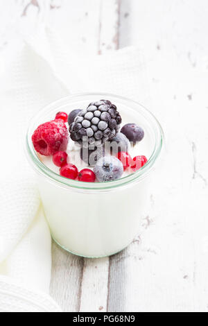 Glass of Greek yogurt with frozen berries Stock Photo