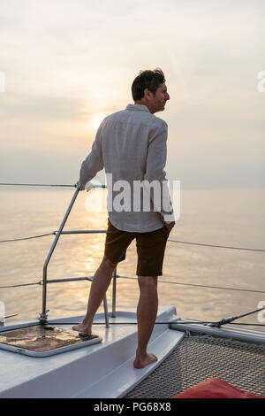 Marure man on catamaran, looking ta view Stock Photo