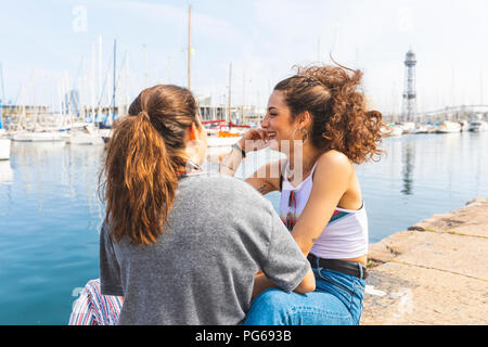 Happy young woman and teenage girl at marina Stock Photo