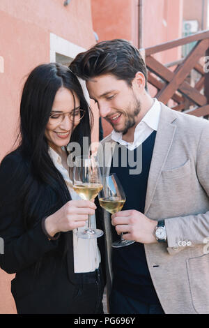 Elegant affectionate couple drinking wine in the city Stock Photo
