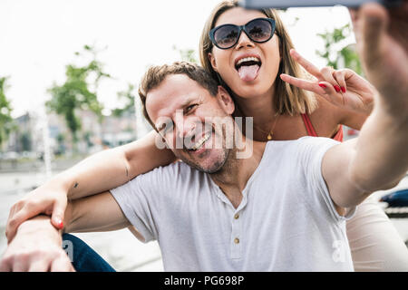 Happy couple taking a selfie outdoors Stock Photo