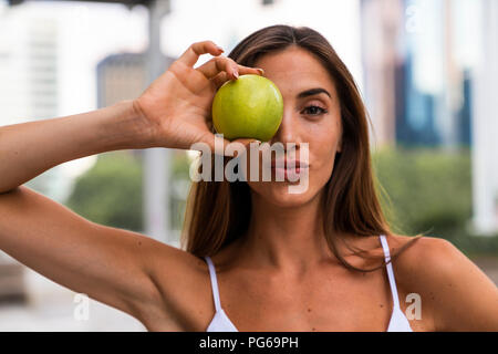 Portrait of attractive young woman holding an apple Stock Photo