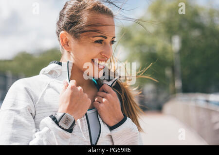Portrait of smiling sportive young woman outdoors Stock Photo