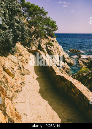 a hiking trail along the cliffs for tourists on the Costa Brava of the Mediterranean Sea in Spain near Lloret de Mar Stock Photo