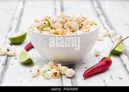 Bowl of popcorn flavoured with chili and lime Stock Photo