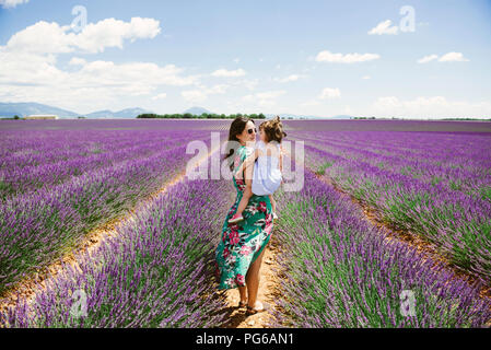 France, Provence, Valensole plateau, Mother and daughter in lavender fields in the summer Stock Photo