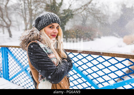 Portrait of smiling teenage girl on snowy day Stock Photo