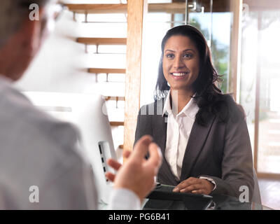 Portrait of smiling businesswoman in a meeting Stock Photo
