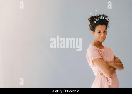 Young woman with molecule model in her hair Stock Photo