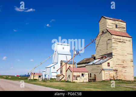 Mossleigh, Alberta, Canada - July 12, 2018: Old weathered wood grain elevators in the small Canadian prairie town of Mossleigh, Alberta, Canada. Stock Photo