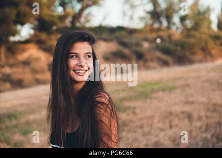 Portrait of laughing teenage girl in nature Stock Photo