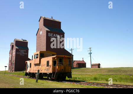 July 13, 2018 - Rowley, Alberta, Canada: Old weathered wood grain elevators in the small Canadian prairie town of Rowley, Alberta, Canada. Stock Photo