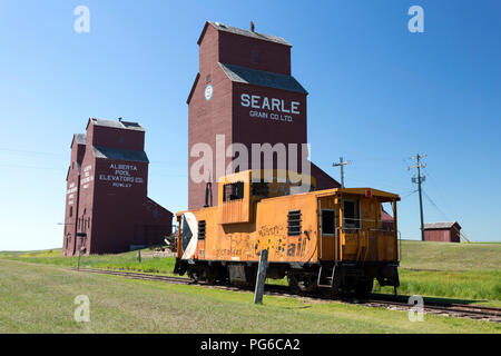 July 13, 2018 - Rowley, Alberta, Canada: Old weathered wood grain elevators in the small Canadian prairie town of Rowley, Alberta, Canada. Stock Photo