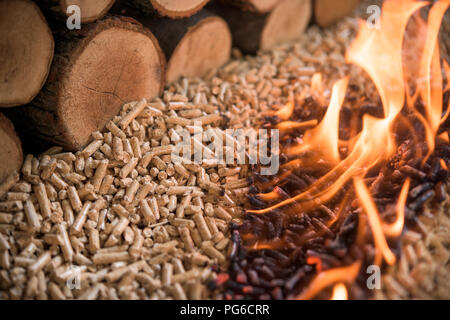 Pile of burning beech pellets and wood - heating Stock Photo