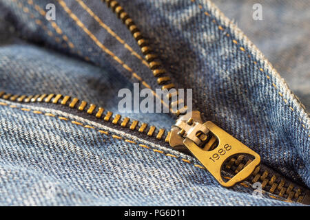 Close up macro shot details of denim blue jeans zipper, selective focus, jeans fashion background concept Stock Photo