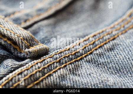 Close up macro shot of denim blue jeans texture background, selective focus. Stock Photo