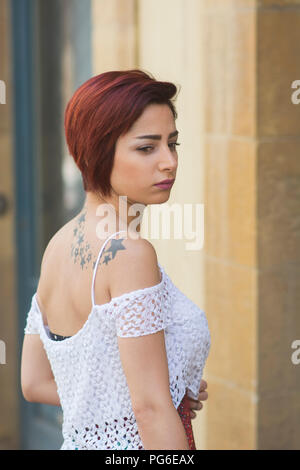 Sad young woman looking voer shoulder Stock Photo