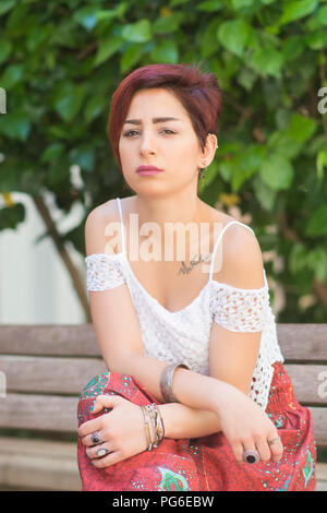 Serious young woman outdoors Stock Photo