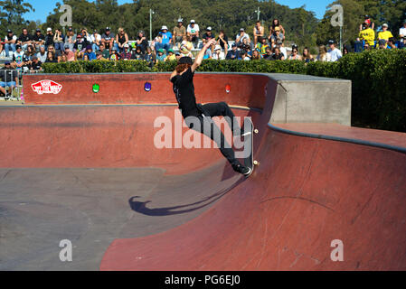 Skateboarding sport in Australia, Coffs Harbour on 18 August 2018. Boy skateboarder showing his skills while spectators watch. Stock Photo