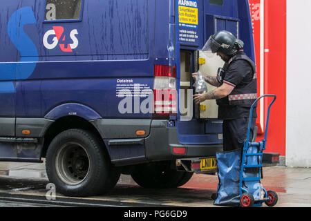 G4S cash in DataTrak transit services, Anti Robbery system delivery & business collection security transport, secure money transfer, professional cash collections and deliveries; driver delivering coins to Preston Bank in Fishergate, UK Stock Photo